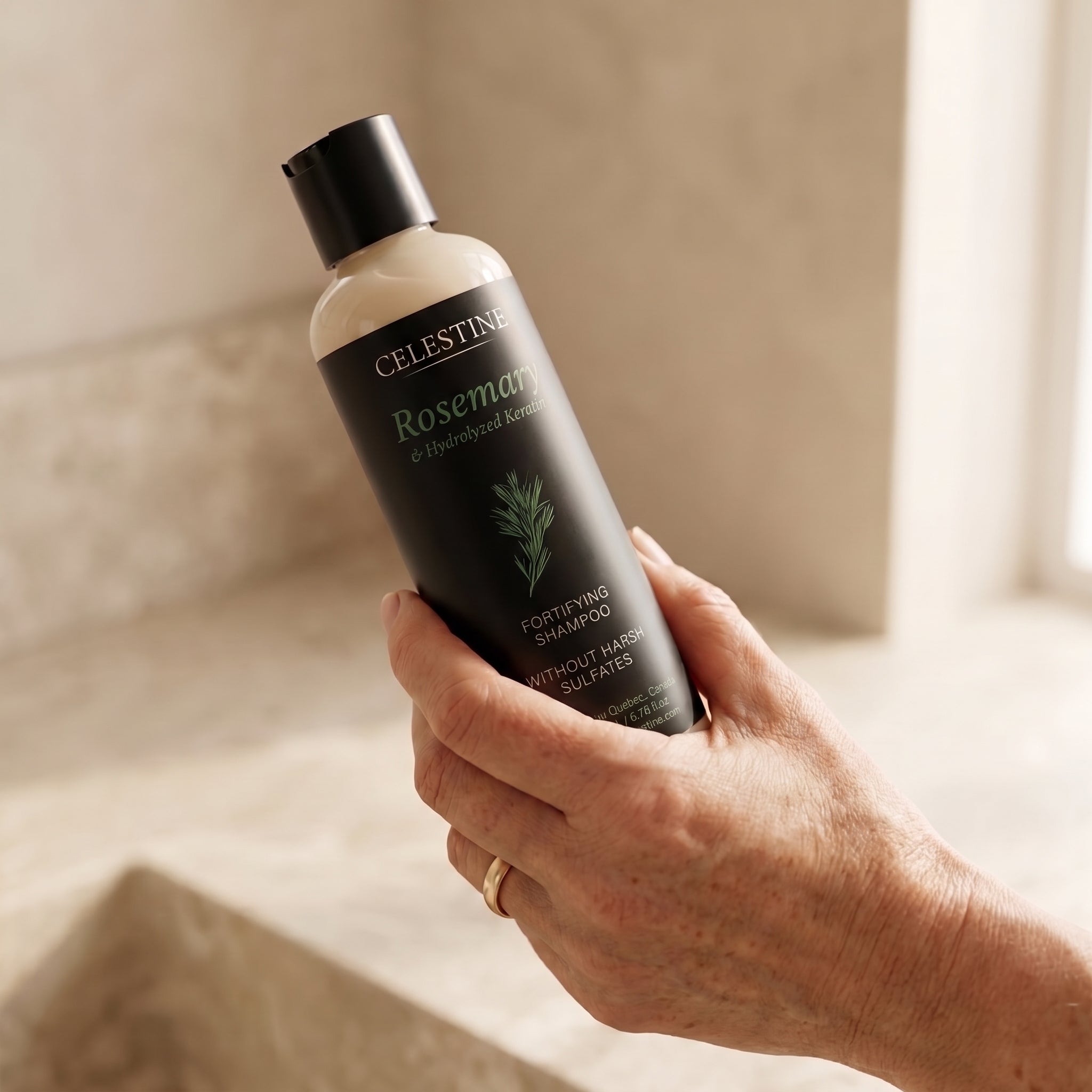 Celestine natural rosemary shampoo on marble with rosemary branch